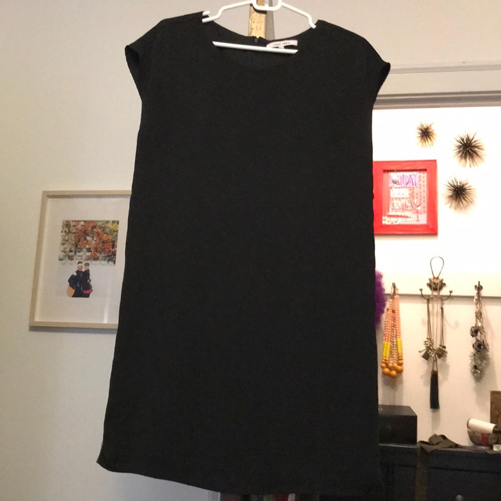 Black shift dress with gold zipper accents